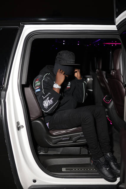 RodSlime in the back seat of a white SUV with the door open.